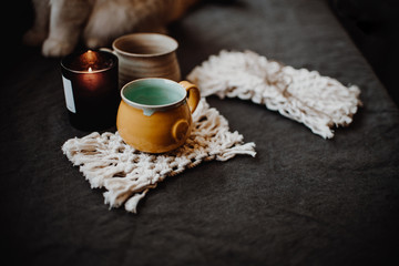 Rustic table with ceramic mugs on dark background