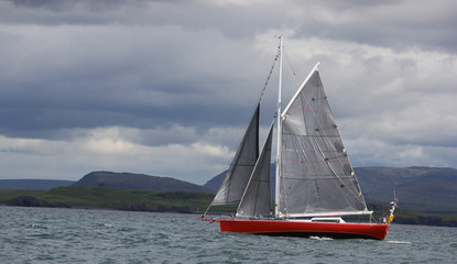 red sail boat in the bay of Reykjavik