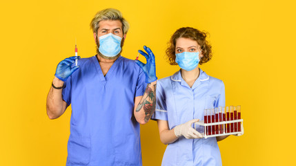 laboratory experiment. stop coronavirus. virus infection injection vaccine. doctors respirator mask. for treating patients. laboratory testing tubes. Doctor in medical mask ready to make injection