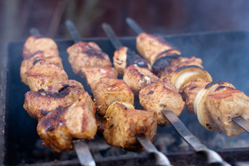 juicy pork skewers on skewers. cooking meat on the grill. in the smoke.