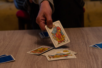 hands holding spanish playing cards