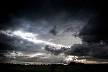 Plakat Scenic View Of Field Against Storm Clouds