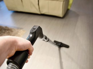 Using vacuum cleaner in home.