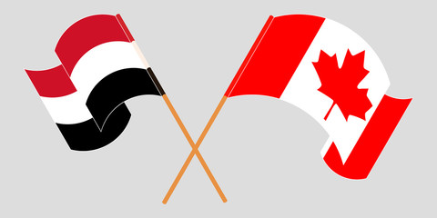 Crossed and waving flags of Yemen and Canada