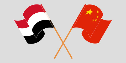 Crossed and waving flags of Yemen and China