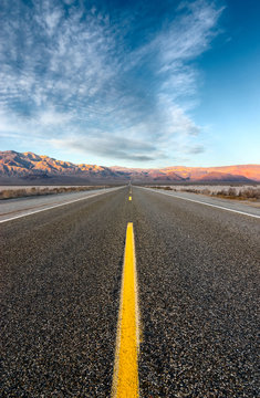 The road crossing the desert and going straight to the mountains.