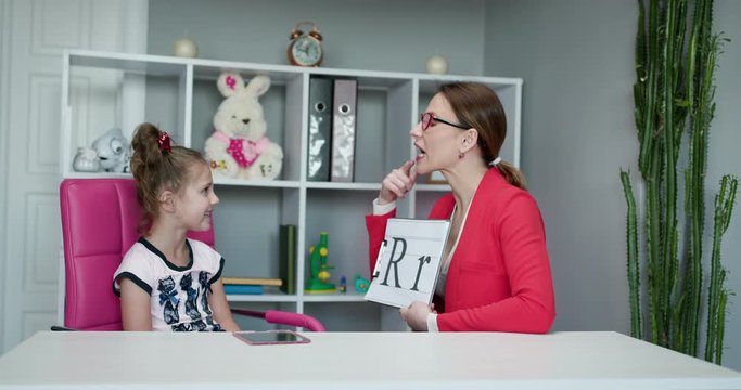 Voice Ability Problem Speaking Lesson Concept. Speech therapist teaches the girls to say the letter R. Female Speech Language Therapist Teaching Preschool Kid Sound Pronunciation