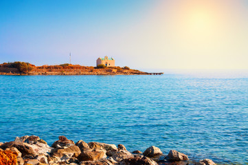Small island with chapel near the coast on Crete island, Greece. Summer landscape