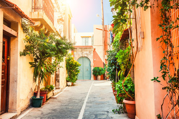 Fototapeta na wymiar Beautiful street with old architecture and green plants in Chania, Crete island, Greece.
