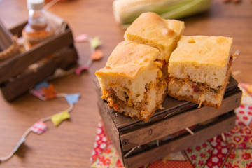 Traditional Brazilian Chicken Pie.  Tipical food from Brazil. June Party (Festa Junina) Brazilian Festival. Arraial Rustic Wood Background. 