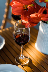 Glass of red wine and flowers