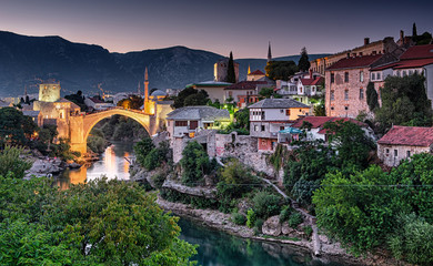 Fototapeta na wymiar Colorful sunset over the medieval bridge of Mostar on 11 August, 2019.