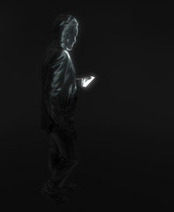 Fototapeta na wymiar Human's figure holds a smartphone in his hand. A black statue of a man on a black background looks at the bright screen of a mobile phone. Modern gadget. Creative conceptual 3D rendering.