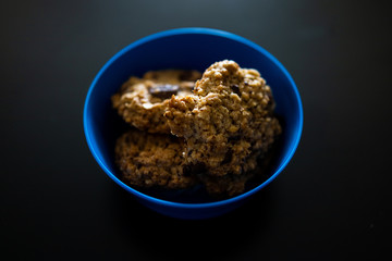 homemade healthy cookies with chocolate chips on a black background.