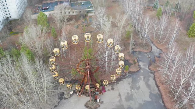 Ferris wheel in Pripyat, Chernobyl. With abandoned buildings in the exclision zone. Aerial video with drone