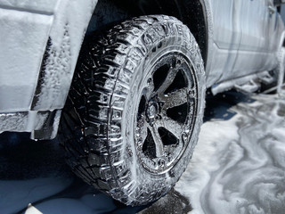 A truck with soapy suds all over it