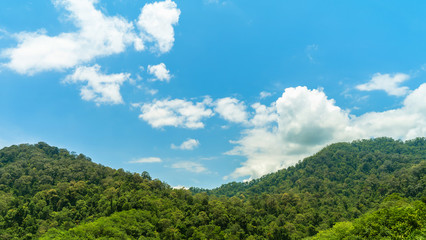 Obraz premium Background, mountains and sky, bright blue clouds, abundant green, comfortable to the eyes