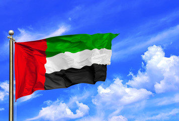 Fototapeta na wymiar United Arab Emirates National Flag Waving In The Wind On A Beautiful Summer Blue Sky