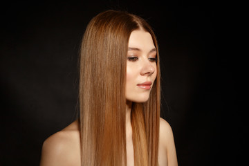 Portrait of a girl with straight hair on a black background