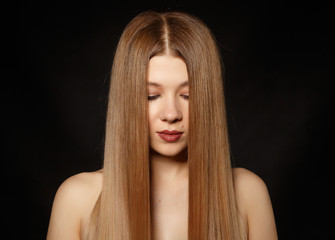Portrait of a girl with straight hair on a black background