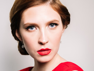 Glamour retro  portrait of a beautiful woman  with  stylish makeup and red lipstick 