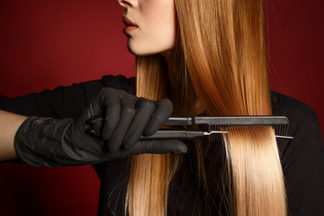 Hair care. Close-up. Hand of a girl with a comb.