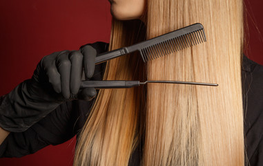 Hair care. Close-up. Hand of a girl with a comb
