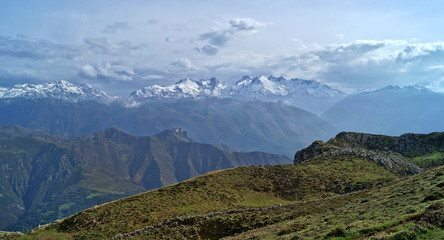 panoramic view from Sierra del Cuera mountains towards Picos de Europa in Asturias with dramatic cloud sky