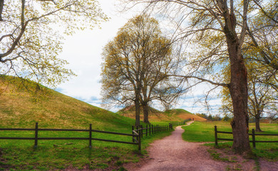 The Royal Mounds (Kungshogarna) three large barrows located in Gamla Uppsala. Archeological site in Sweden near Stockholm.