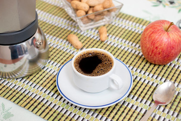 cup of expresso coffee with peanuts and fruit