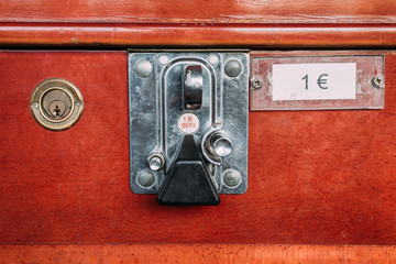 Closeup of metal insert coin slot on retro tabletop football game with red board with 1 euro price