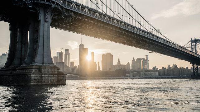 Fototapeta Modern cityscape with bridge over river in evening