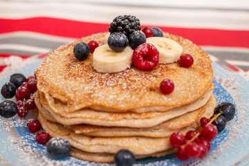 oats and banana pancakes with berries
