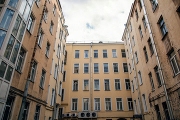 View of the courtyard of the yellow house. Wells St. Petersburg at home.Windows of a big city.