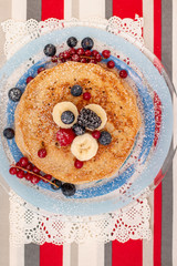 oats and banana pancakes with berries