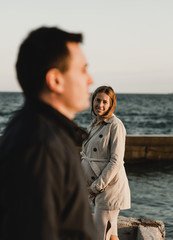 Young pregnant couple in love on summer sunny evening. at sunset on the beach,Beautiful young couple expecting a baby. A happy family. Pregnant mother and best father