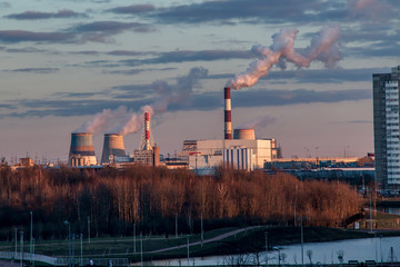 Picturesque sunset over the chimneys of a thermal power plant. 