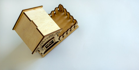 Wooden miniature house. Beautiful white background, copy space.