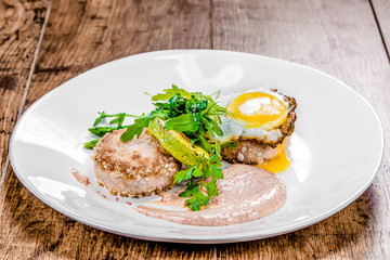 A plate of crab cutlets on a table