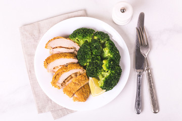 Chicken grilled fillet filled with julienne, lemon and steamed broccoli. Healthy food, ketogenic diet. Keto/Paleo