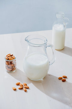 Jar of milk and almonds on table