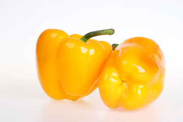 Two yellow bell peppers isolated on white