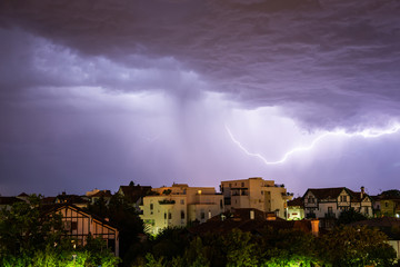Naklejka na ściany i meble Thunderstorm at night in Bayonne, France
