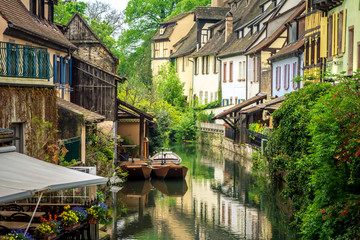 Fototapeta na wymiar Traditional french houses and old boats on the side of river Lauch in Petite Venise, Colmar, France