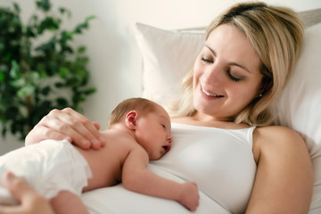 A woman with a newborn baby in bed