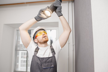 Electrician is repairing lighting fixtures for lamp and spot loft style on ceiling