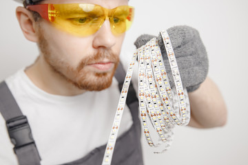 Electrician installing mounting tape LED strip light decorative lighting