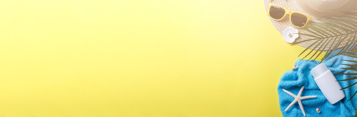 Beach accessories on the yellow background