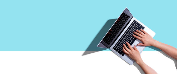 Person using a laptop computer from above