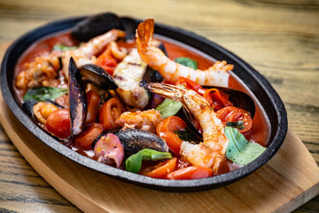 Bowl of seafood, prawns, shrimps, fish, tomatoes